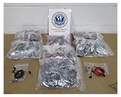 Photograph of bags of seized counterfeit Beats earphones