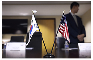 Flags of Korea and the United States placed on a conference room table