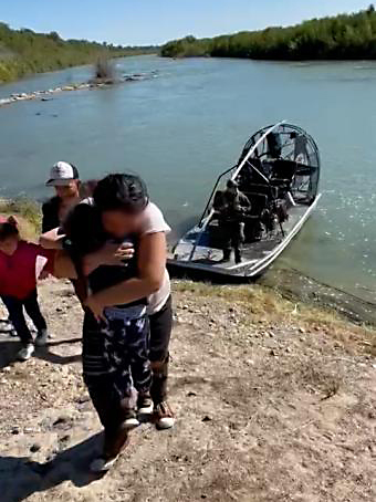 A 5-yr-old girl is reunited with her mother after human smugglers left the girl on an island in the Rio Grande