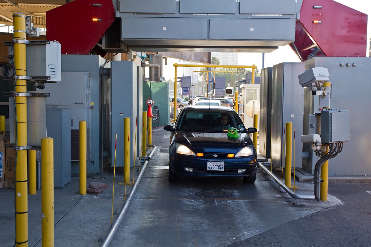 A car passes through an inspection booth and hi-tech scanners at the San Ysidro, Calif. port of entry. (photo by Josh Denmark)