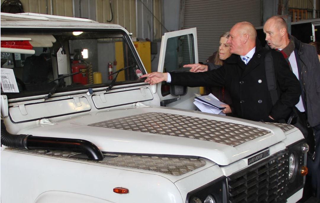 Photo of Operation Atlantic partners examining a Land Rover Defender