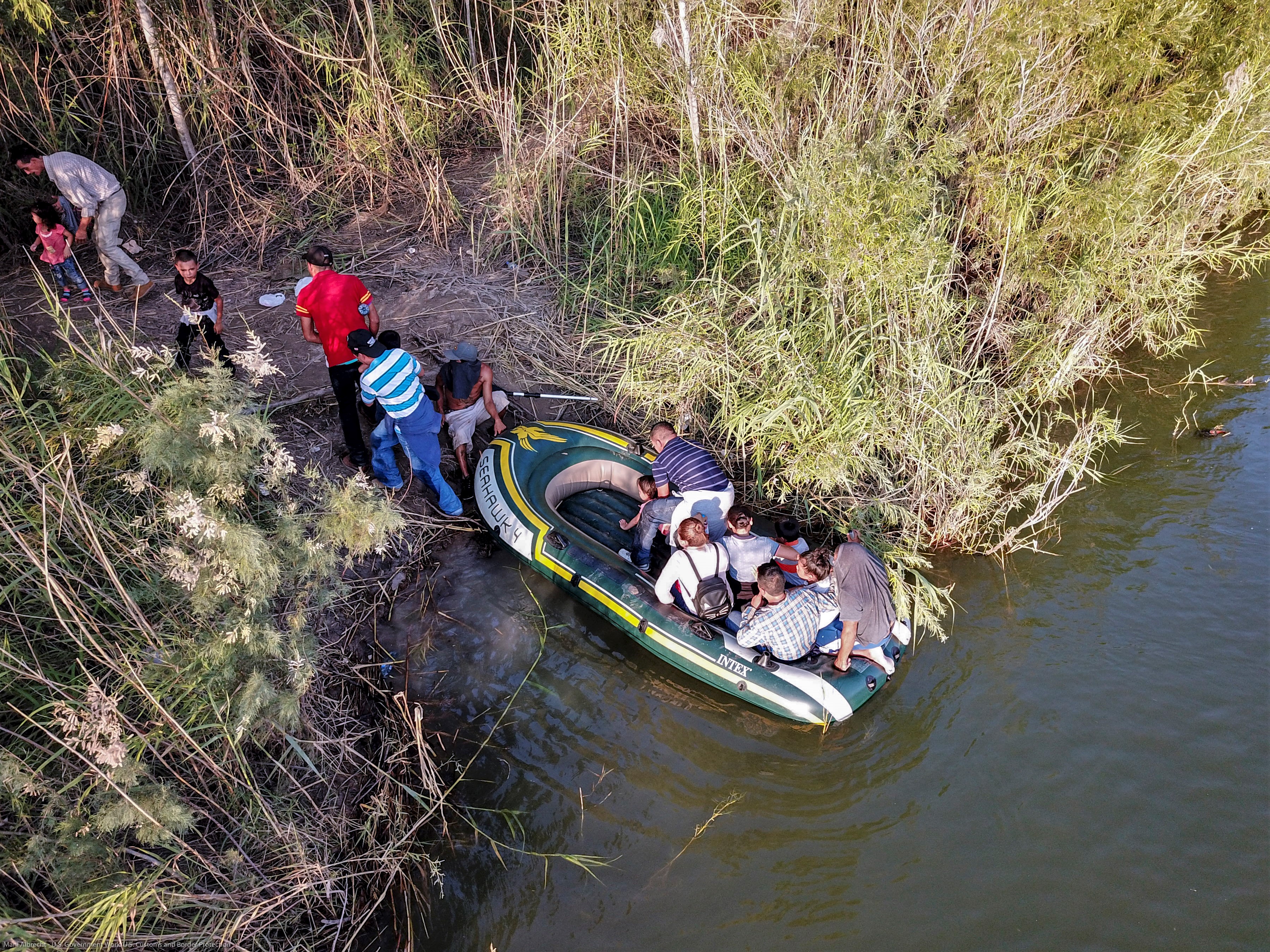 A group of illegal aliens use a raft to enter the United States