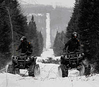 Border Patrol Agents patrolling the northern border on snowmobiles