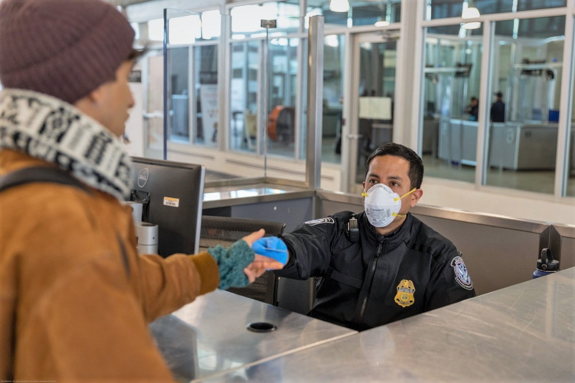A CBP officer talks with a traveler
