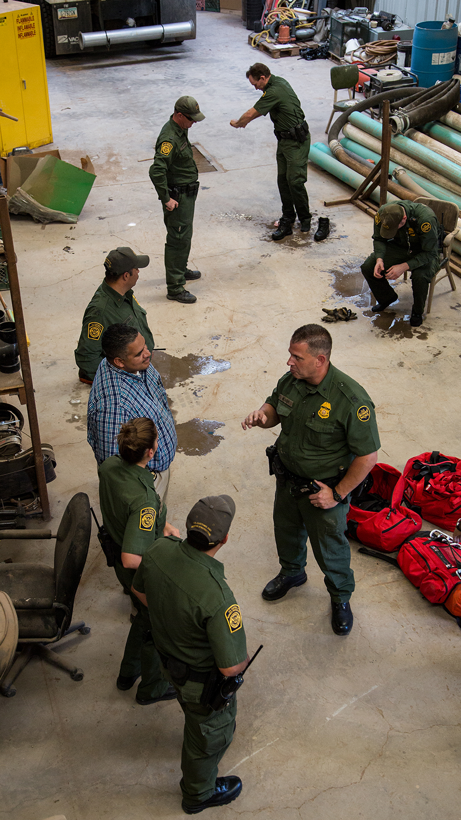 Border Patrol agents gather after exploring the tunnel. The building where the tunnel exits on the U.S. side of the border is now municipally owned building.