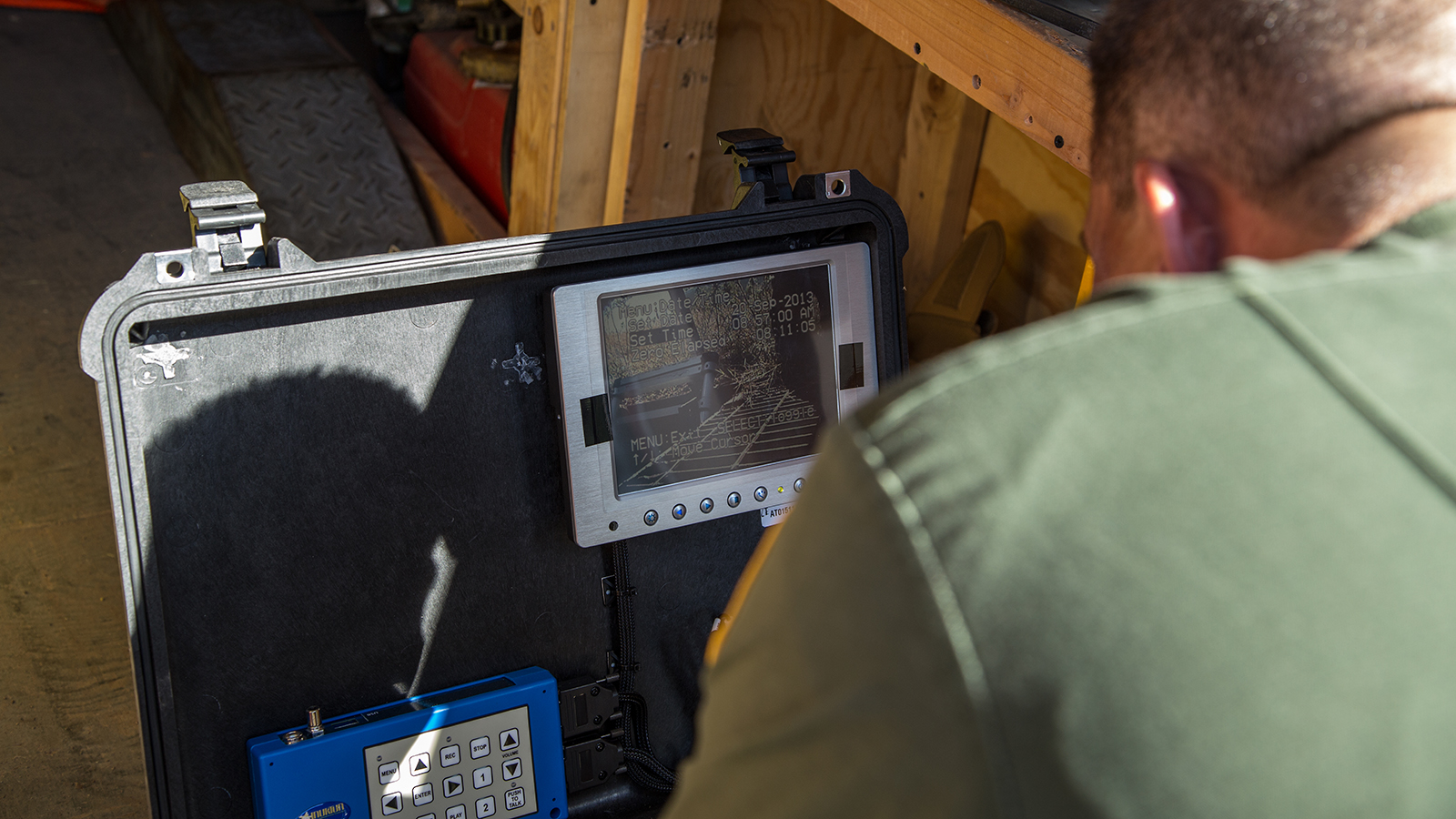 Supervisory Border Patrol Agent Kevin Hecht monitors the information relayed to a console by the robot as it explores the tunnel.