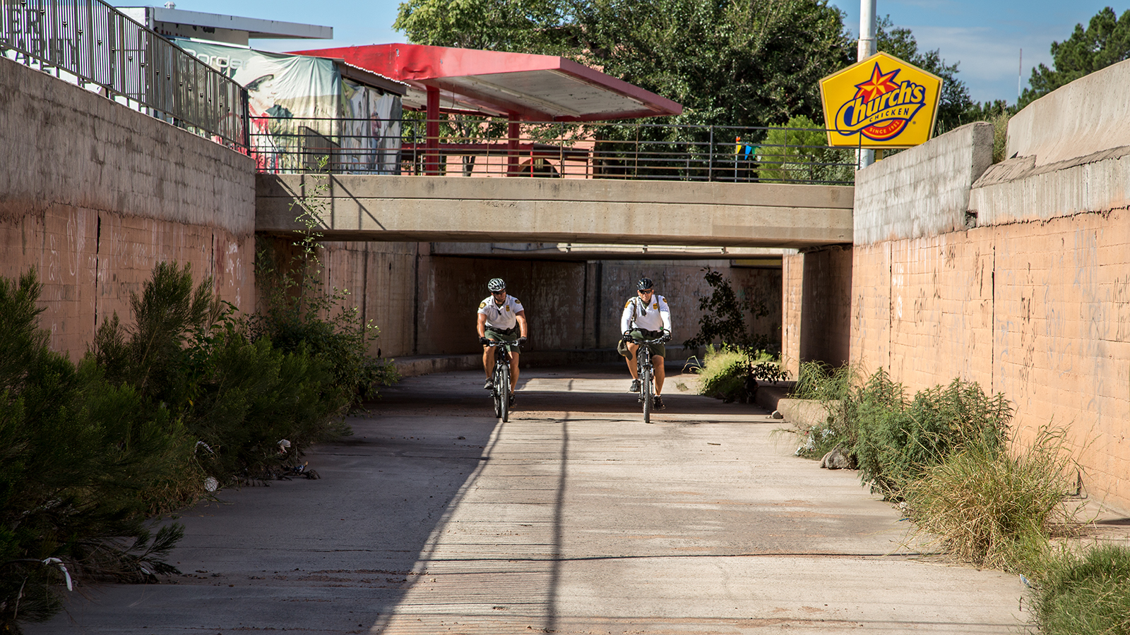 Border Patrol agents patrol the main drainage system on bikes in Nogales, Arizona.