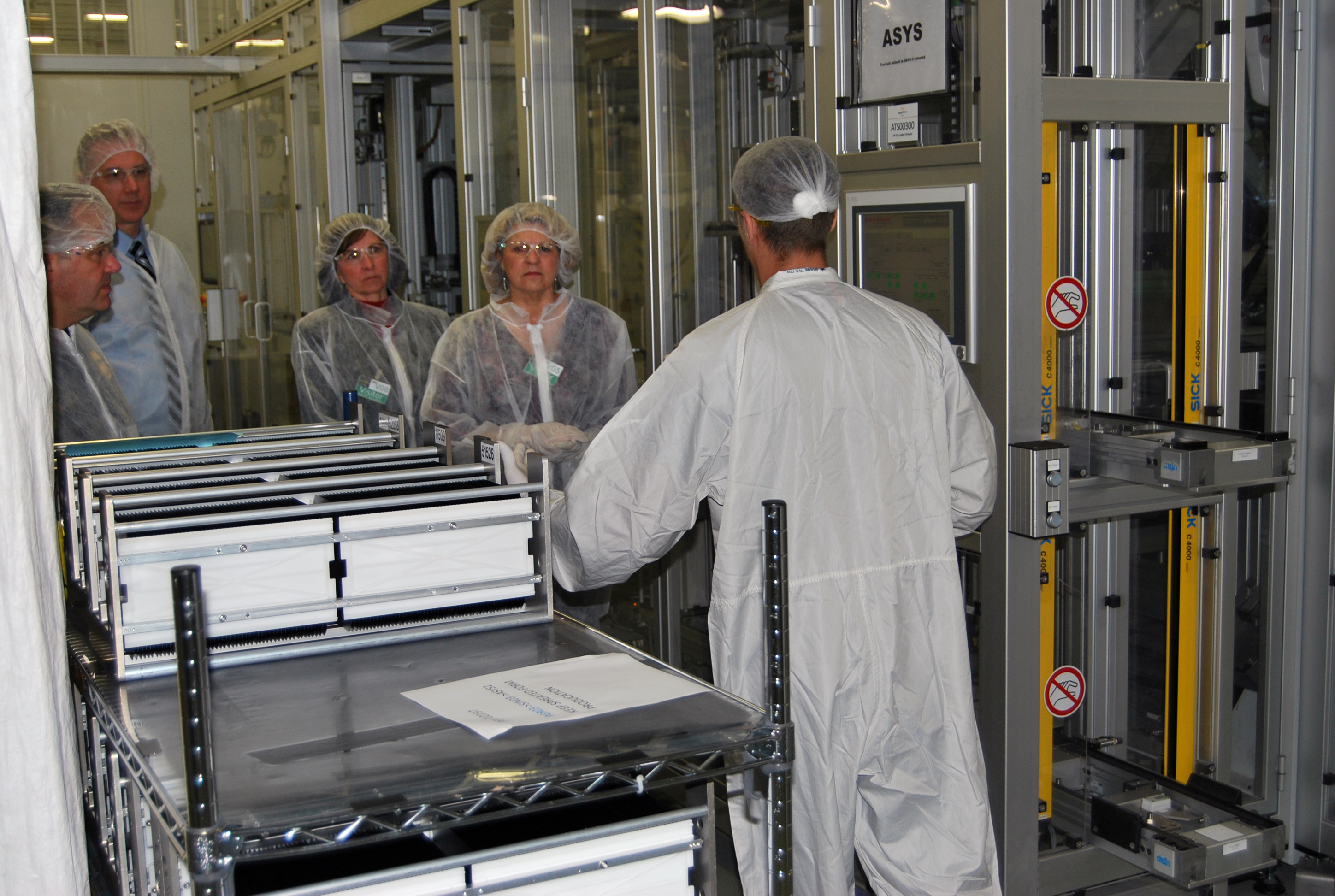A SolarWorld employee shares details of solar cell production with CBP employees, l-r, Erich Mohr, Steve Lewis, Kristy Huckins and Katie Schultz. Photo by Ed Colford