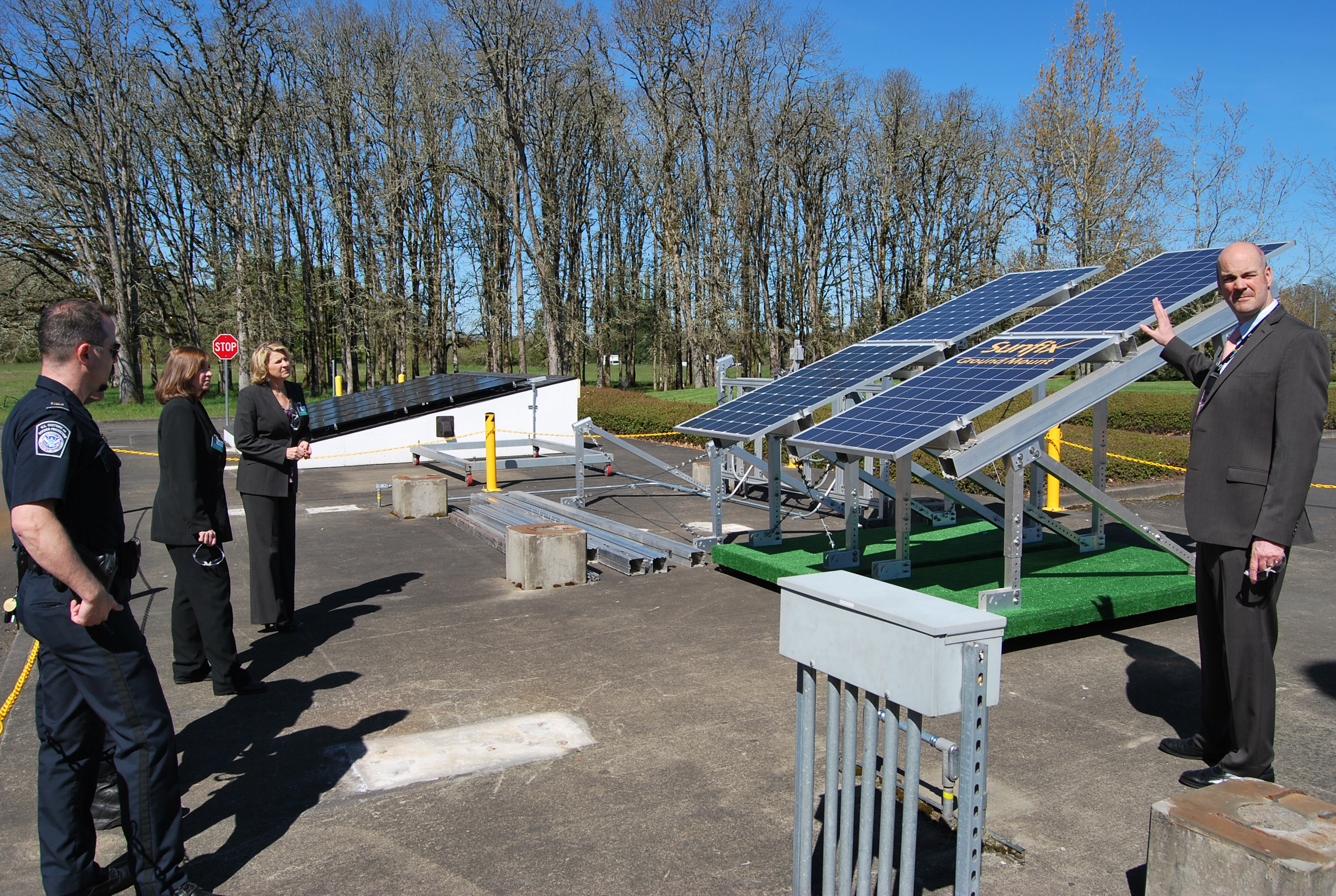 Steve Pecis, SolarWorld’s director of operations, demonstrates how solar panels collect the sun’s energy on the grounds of SolarWorld’s Hillsboro, Oregon facility. CBP Officer William Wells, left foreground; Import Specialist Kristy Huckins, center; and Senior Import Specialist Katie Schultz, far left, listen. Photo by Ed Colford