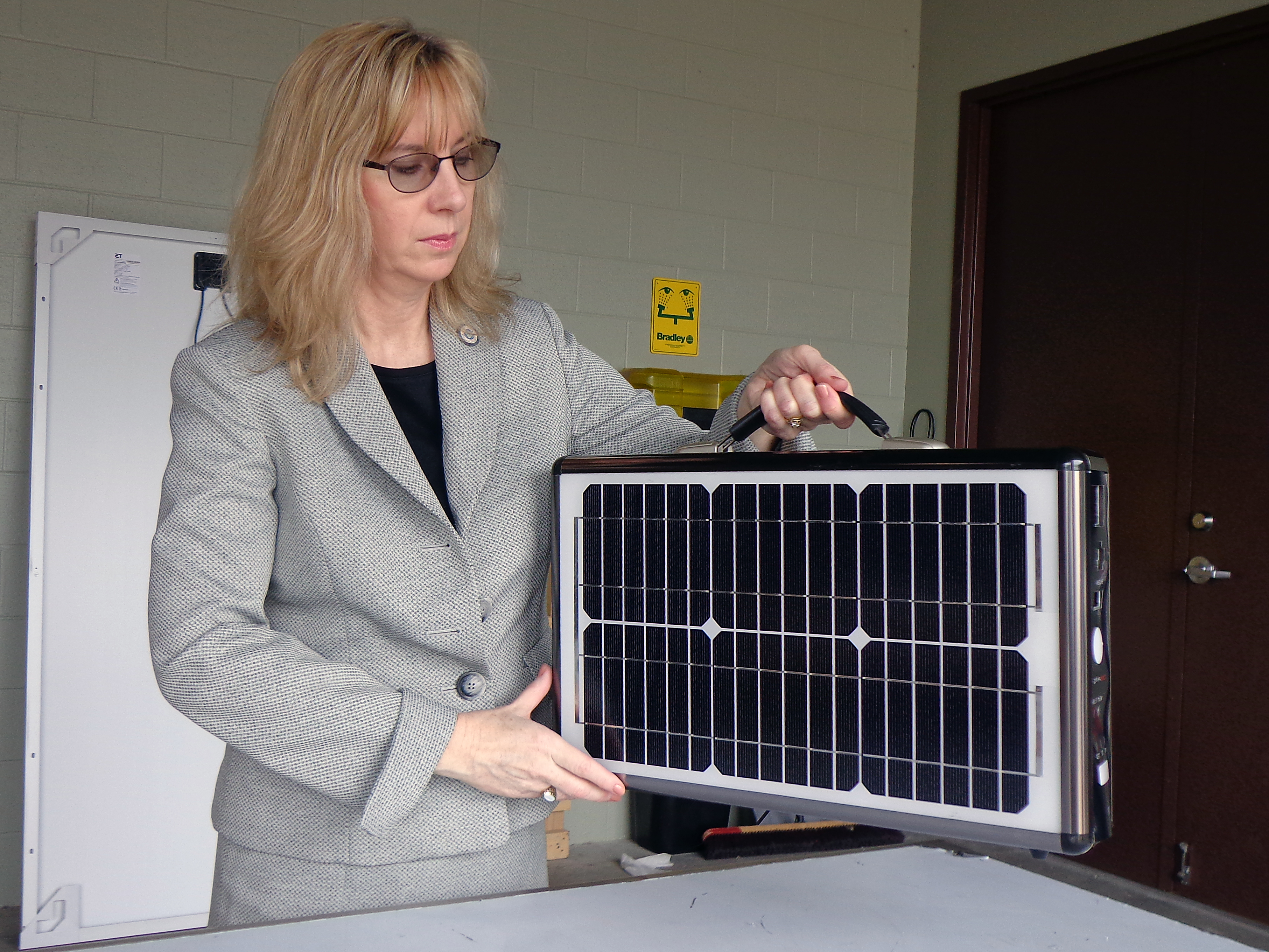 Senior Import Specialist Laurie Pazzo inspects a mobile solar power unit that was listed on shipping documents as a suitcase. Photo by Scott Sams