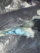 Fentanyl Pills concealed in black saran wrap  