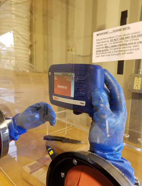 One of many devices used in the field to detect contraband, this TruNarc substance analyzer identifies multiple types of narcotics. The gloved manipulators protect officers while testing for drugs. Photo courtesy of CBP NTC