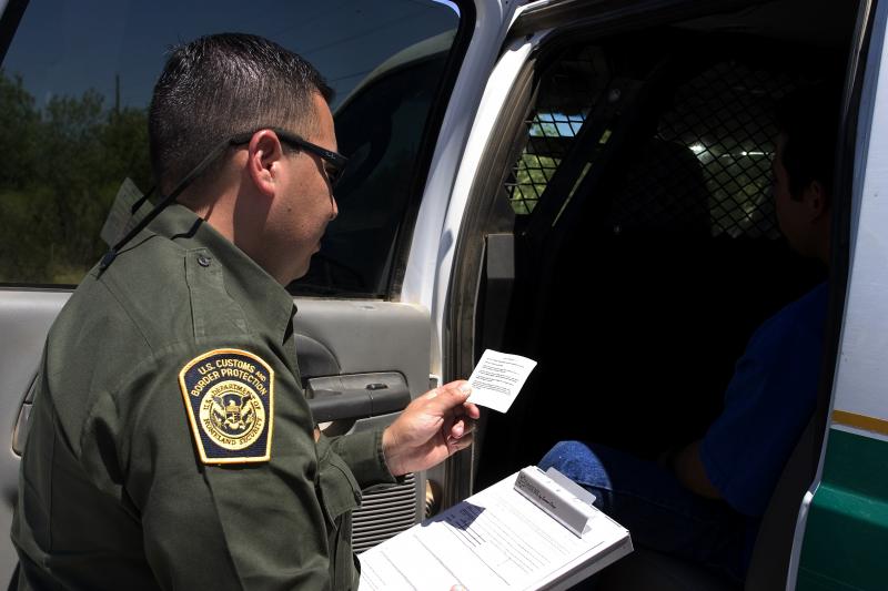 Border Patrol agent checks identity documents 