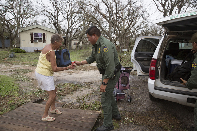 U.S Border Patrol agent Mario Fuentes assists Diane Market to his vehicle as he and his partner conduct search and rescue operations in the wake of Hurricane Harvey near Rockport, Texas. (August 27, 2017) U.S. Customs and Border Protection Photo: Glenn Fawcett