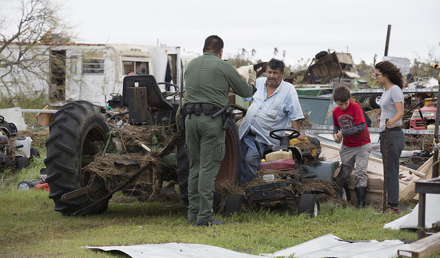 U.S Border Patrol agent Mario Fuentes talks with a family after Hurricane Harvey near Rockport, Texas. (August 27, 2017) U.S. Customs and Border Protection Photo: Glenn Fawcett