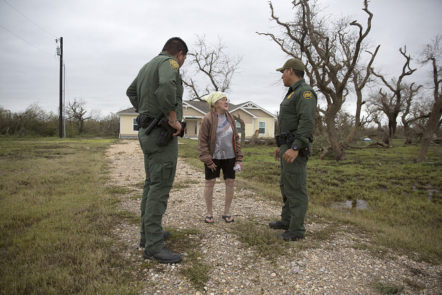 U.S Border Patrol agents Mario Fuentes, left, and Marc Gonzales talk with a woman who rode out Hurricane Harvey in her home near Rockport, Texas. (August 27, 2017) U.S. Customs and Border Protection Photo: Glenn Fawcett