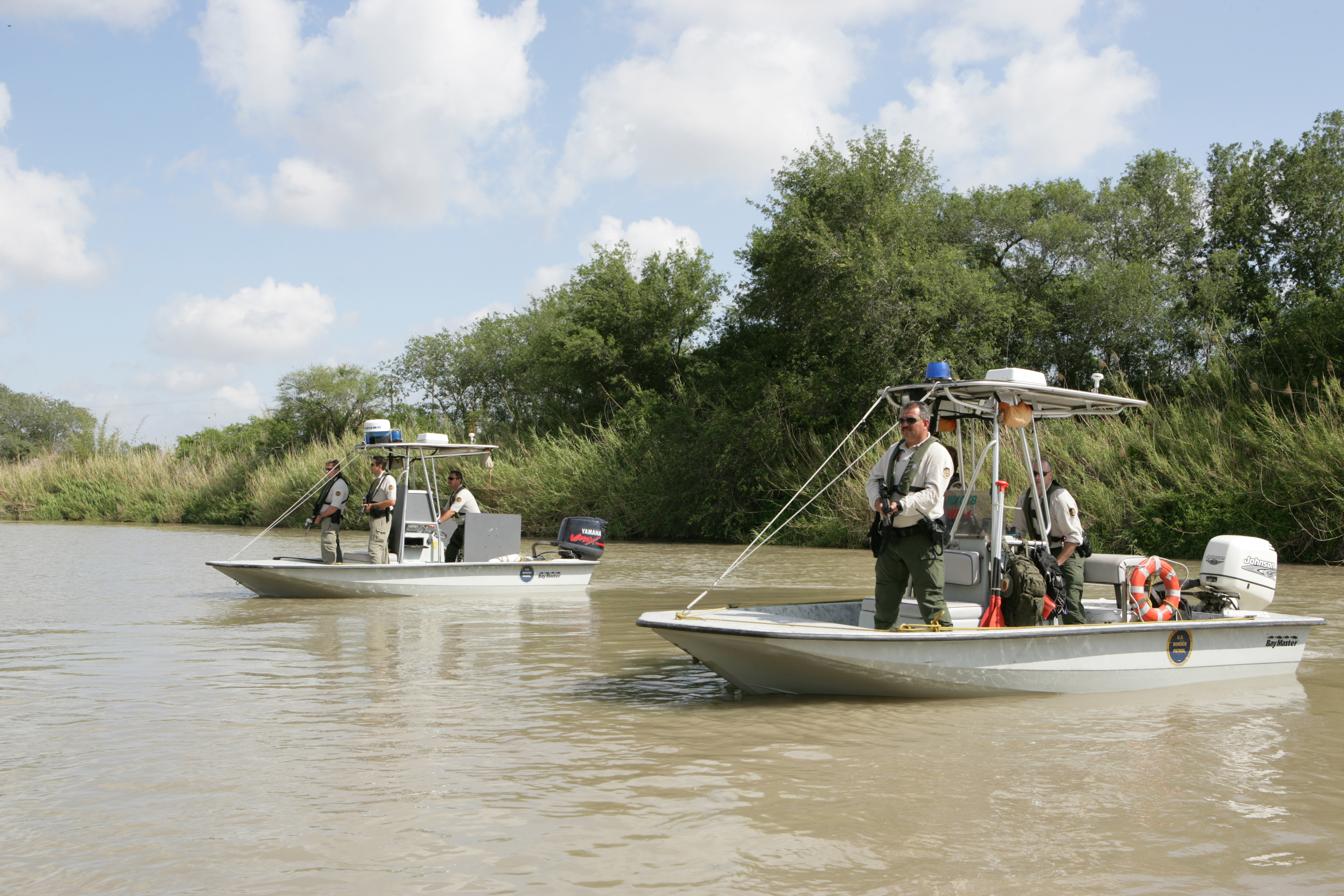 U.S. Border Patrol Marine units face toward Mexico to provide cover for other agents on the U.S. side of the river conducting an investigation.