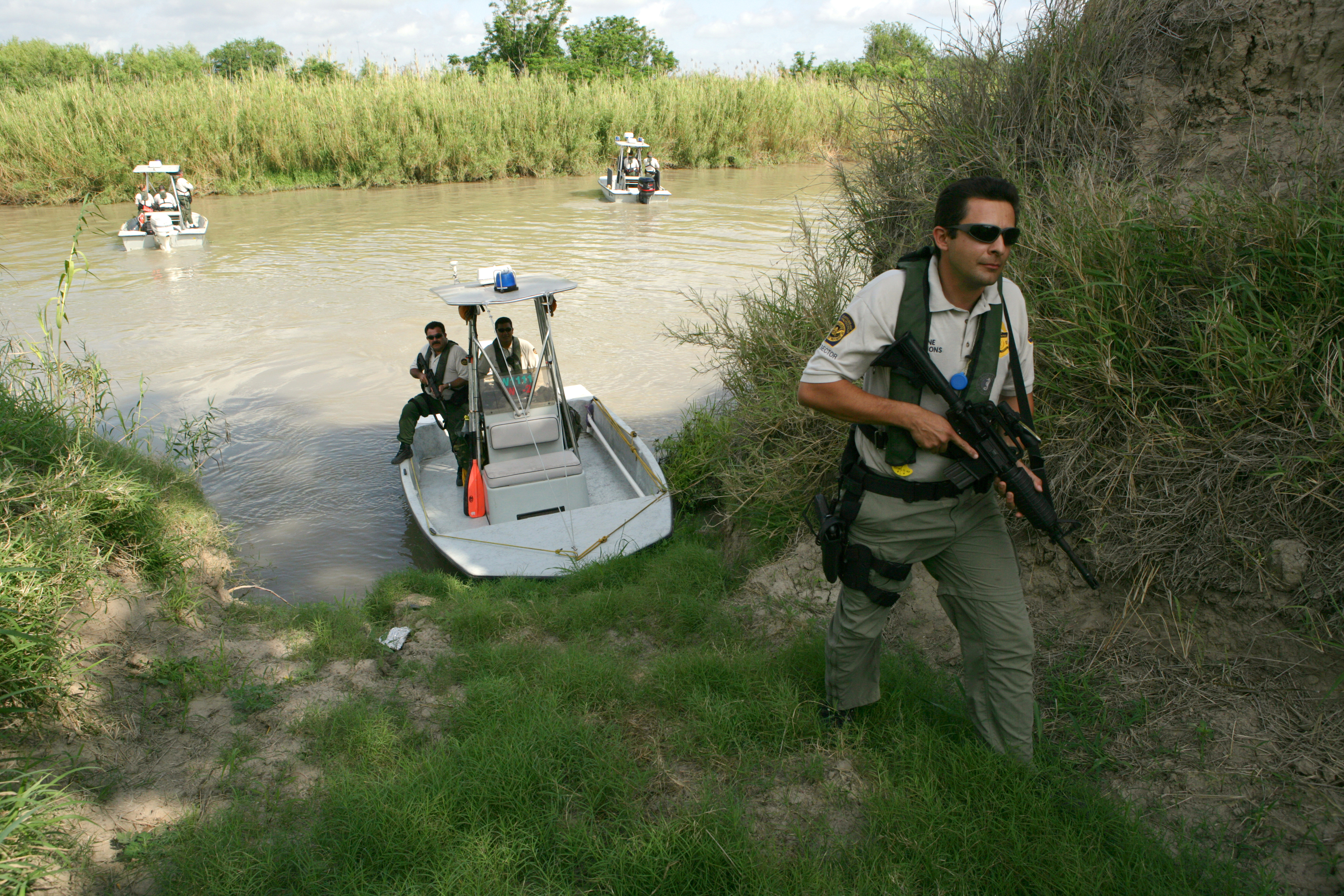 U.S. Border Patrol agent investigates a potential landing area for illegal immigrants along the Rio Grande River in Texas.