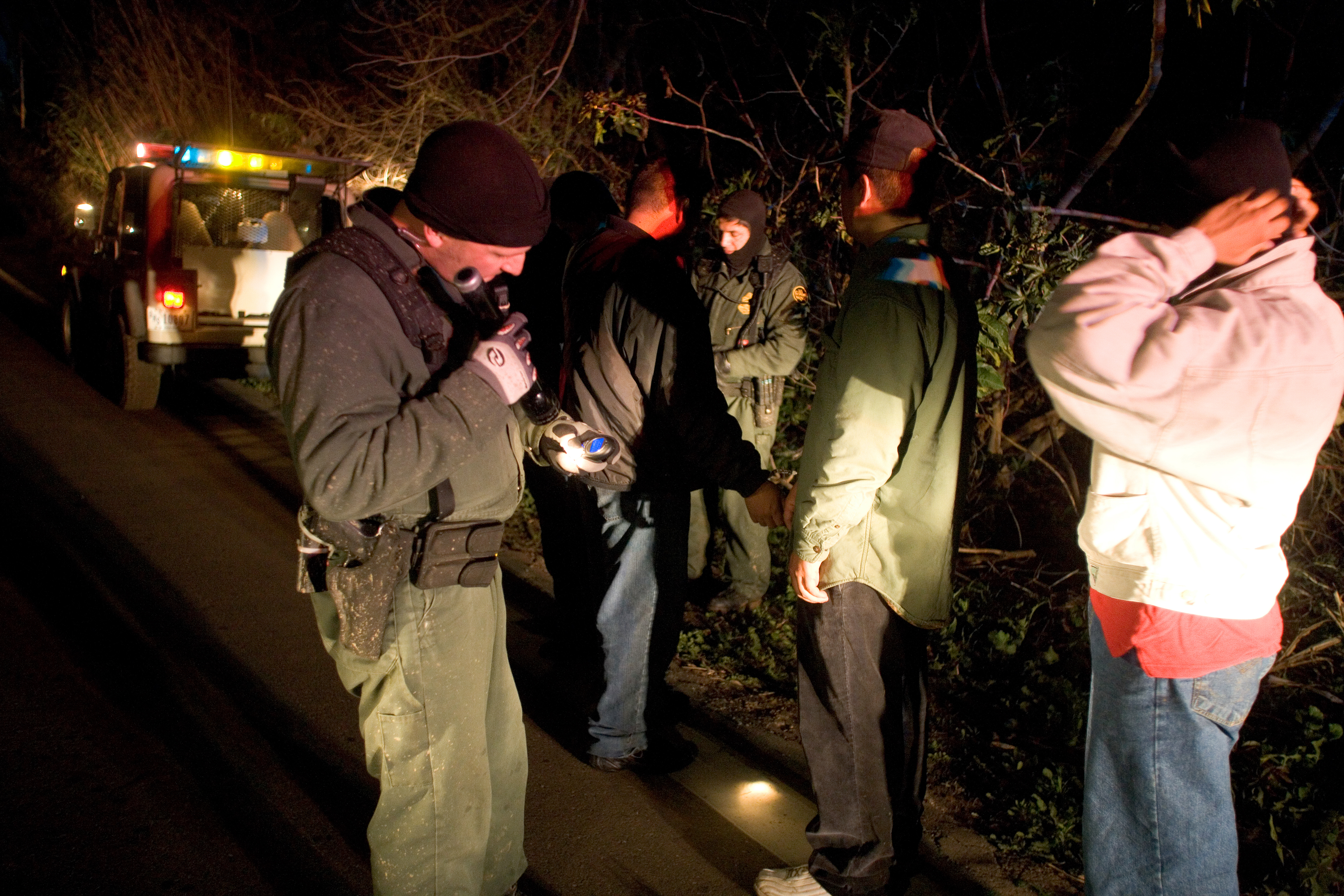 Border Patrol agents conduct pat downs of migrants caught crossing the border illegally in the Imperial Valley Sector.