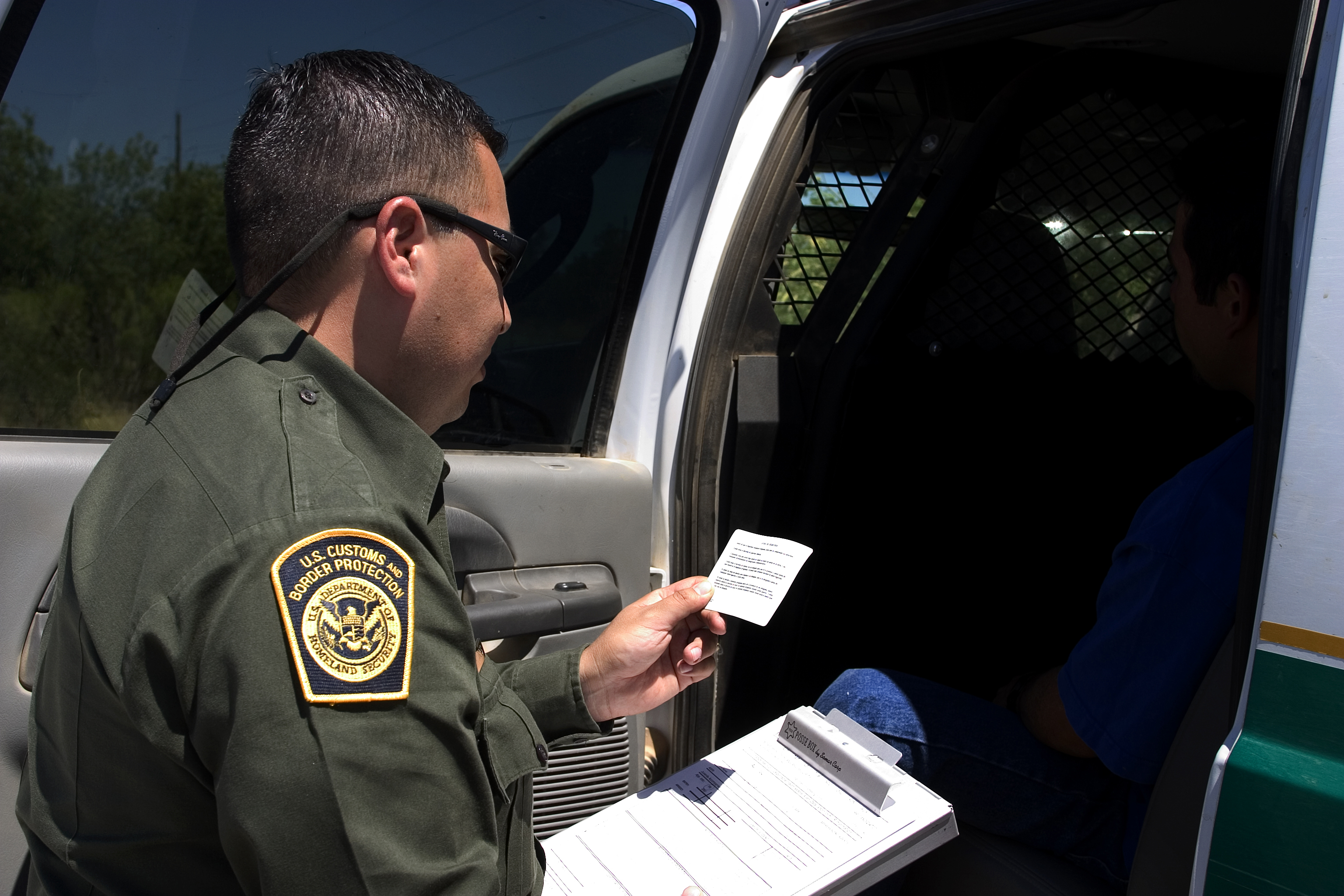 U.S. Border Patrol agent reads the Miranda rights to a Mexican national arrested for transporting drugs.