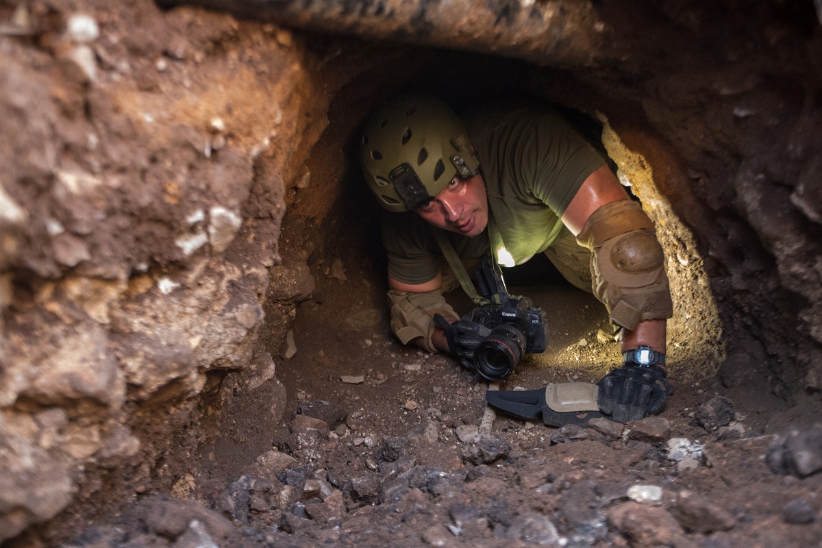 A Border Patrol agent inspects a man-made tunnel near Nogales, Ariz. Such tunnels are used to transport drugs under the U.S. border. (photo by Josh Denmark)