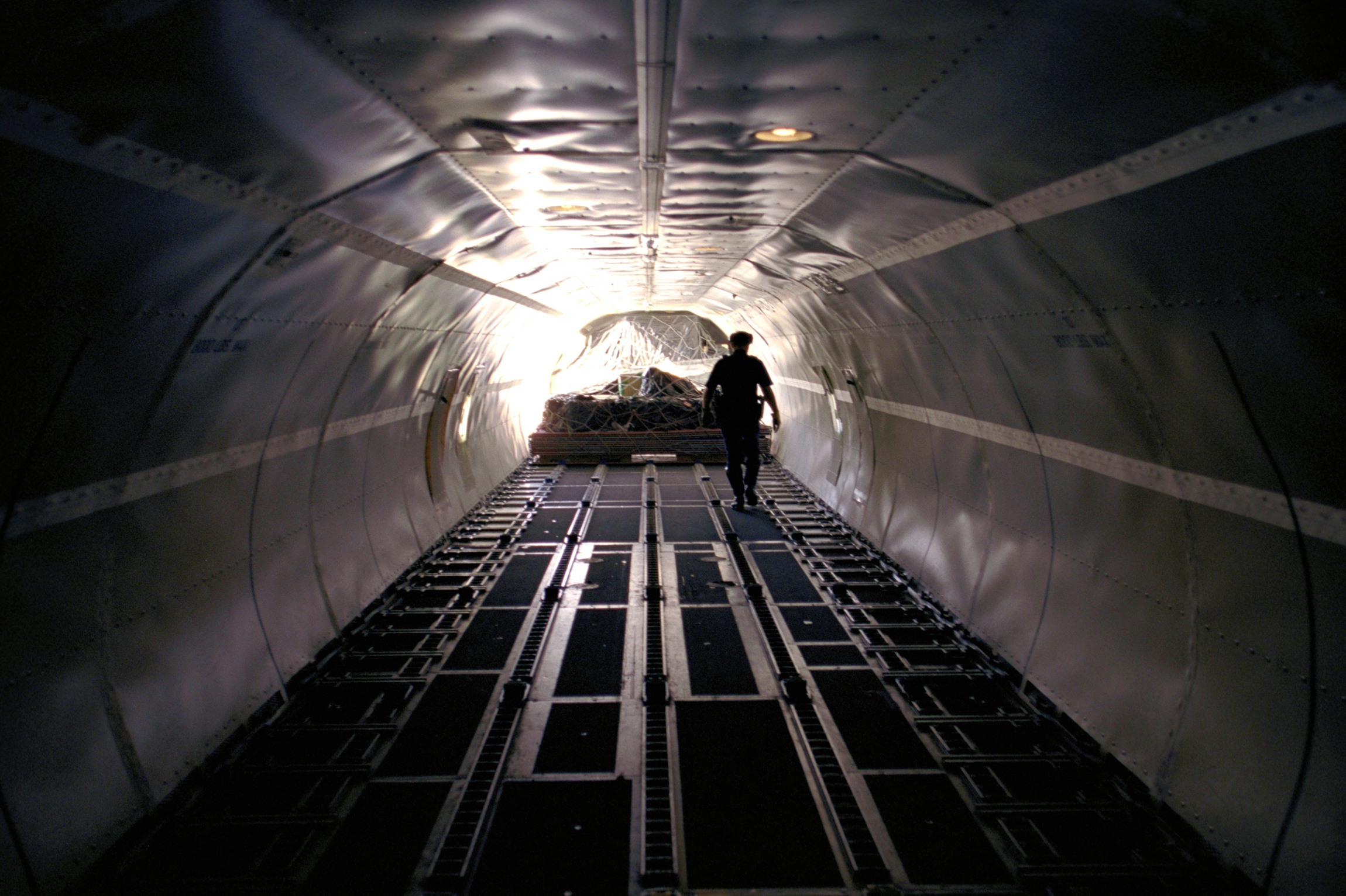 A CBP Officer examines the last bit of cargo to be off loaded from an aircraft.