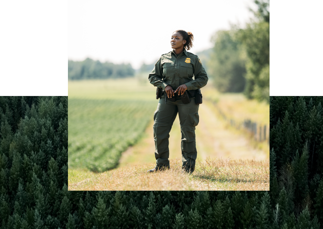 Female Border Patrol Agent standing in a field