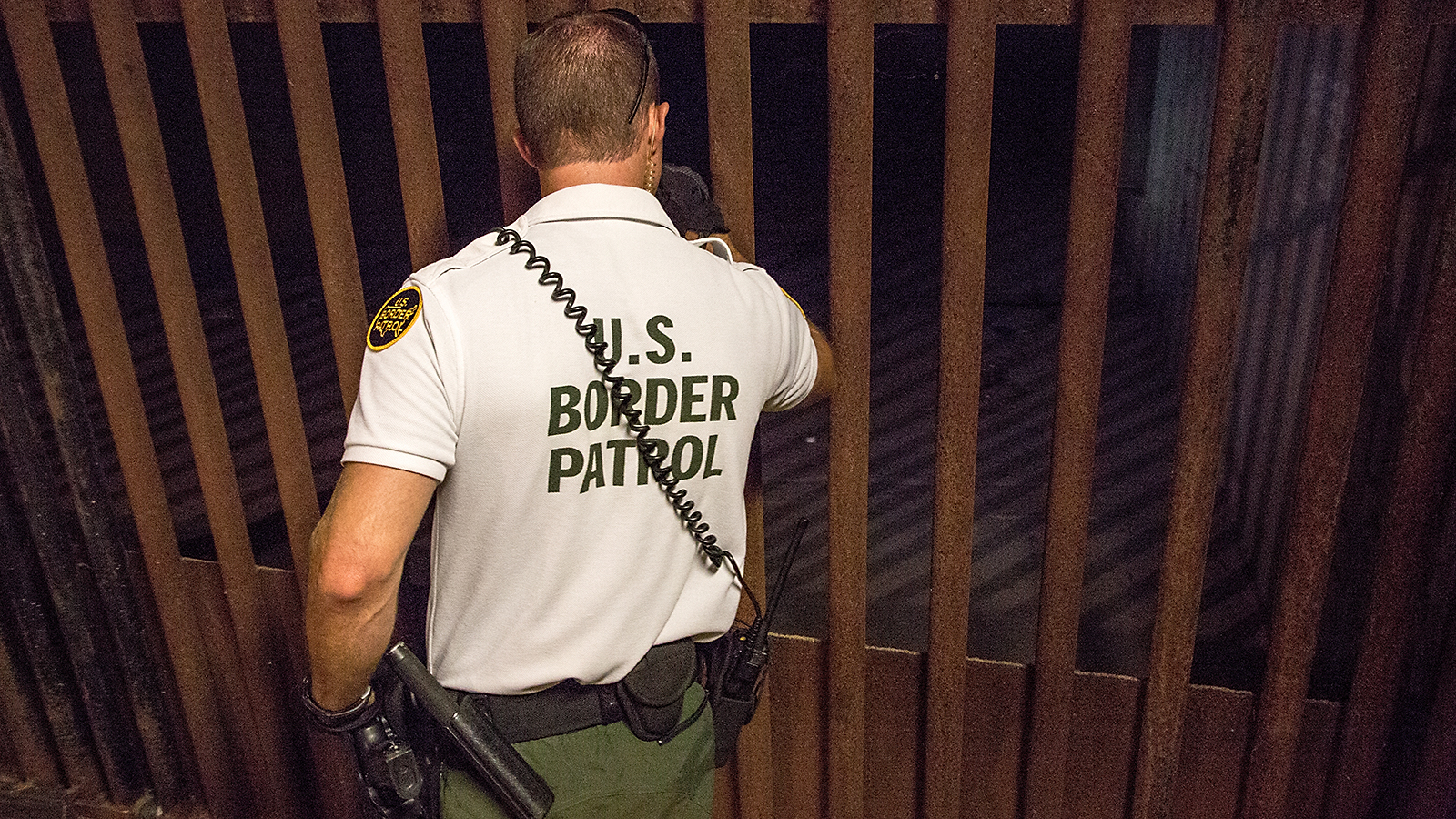 Photo of Border Patrol agent inspecting drainage gates