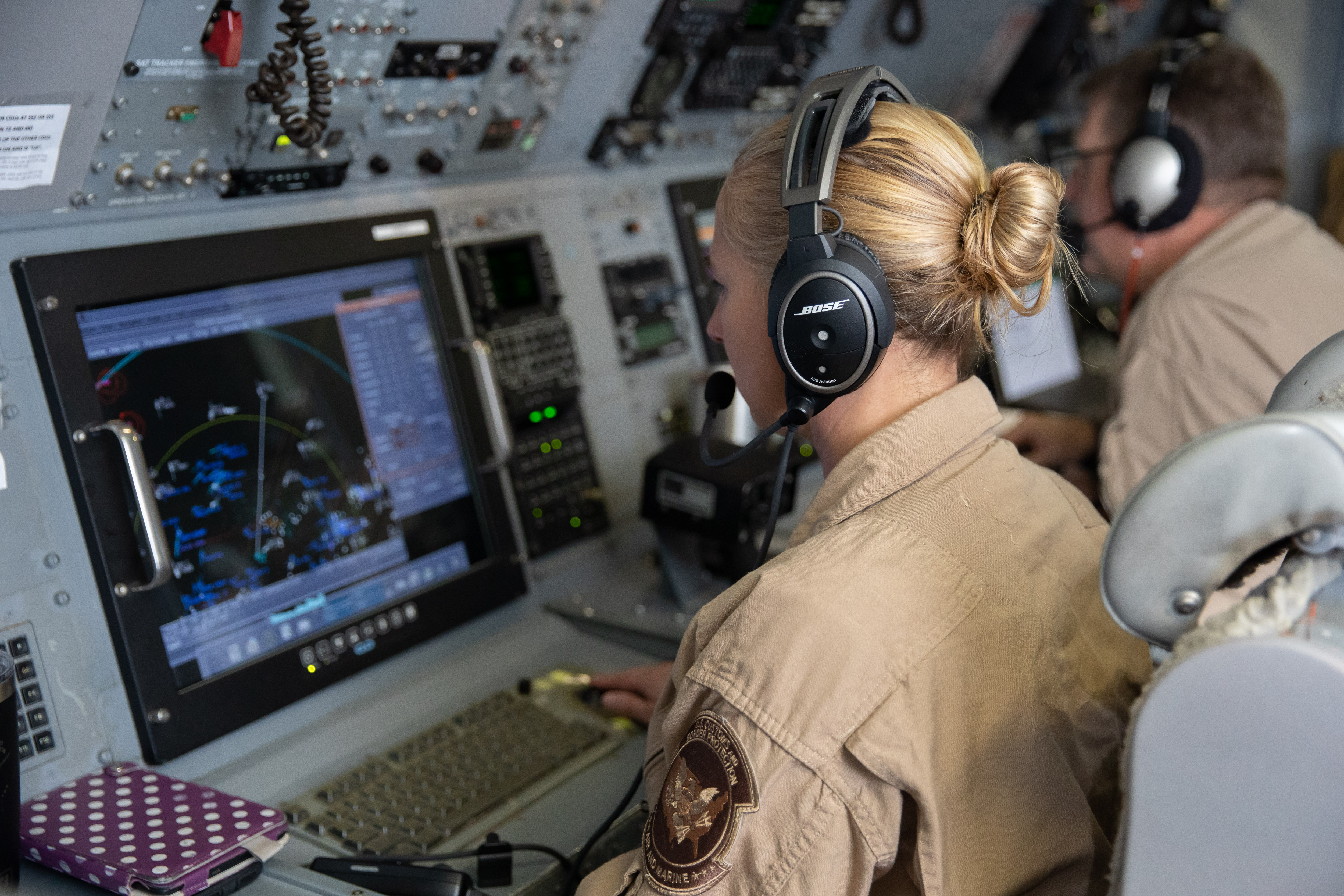 An aviation enforcement agent watches the radar in an AMO aircraft.