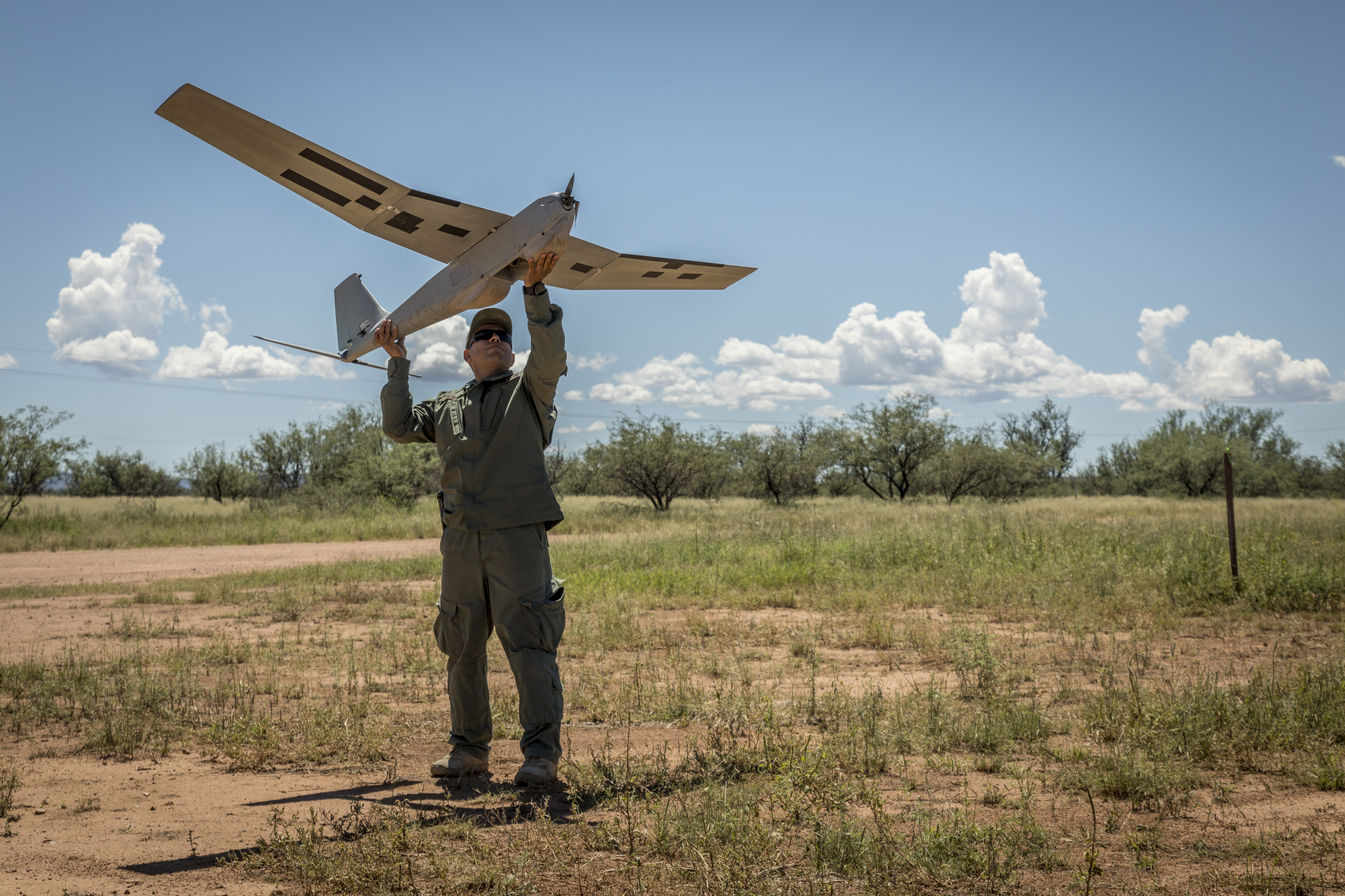 Supervisory Border Patrol Agent Jeffrey McBride launches a drone. 