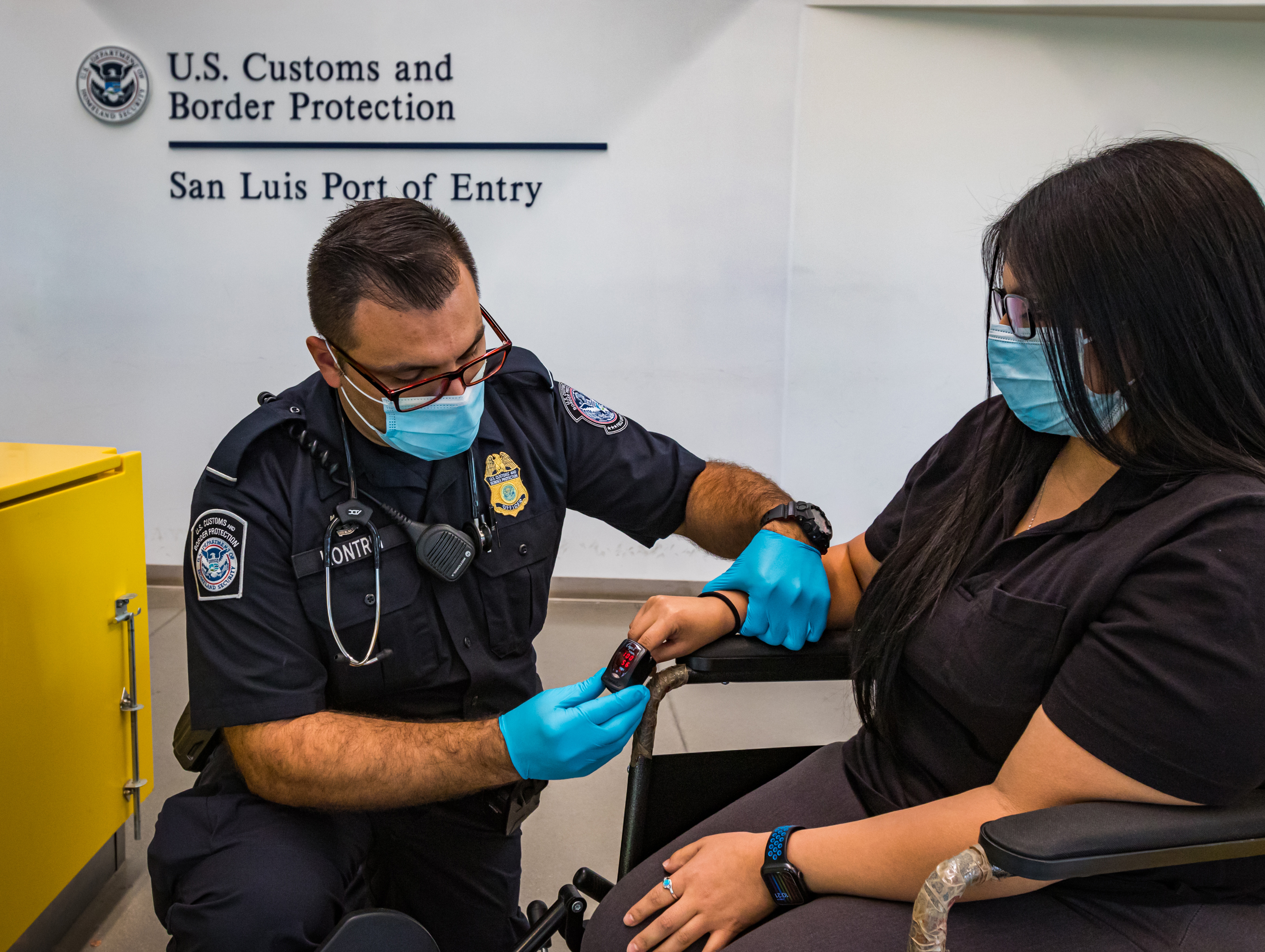 Hristijan Kontrin helps a patient at the Port of Entry San Luis, Arizona.
