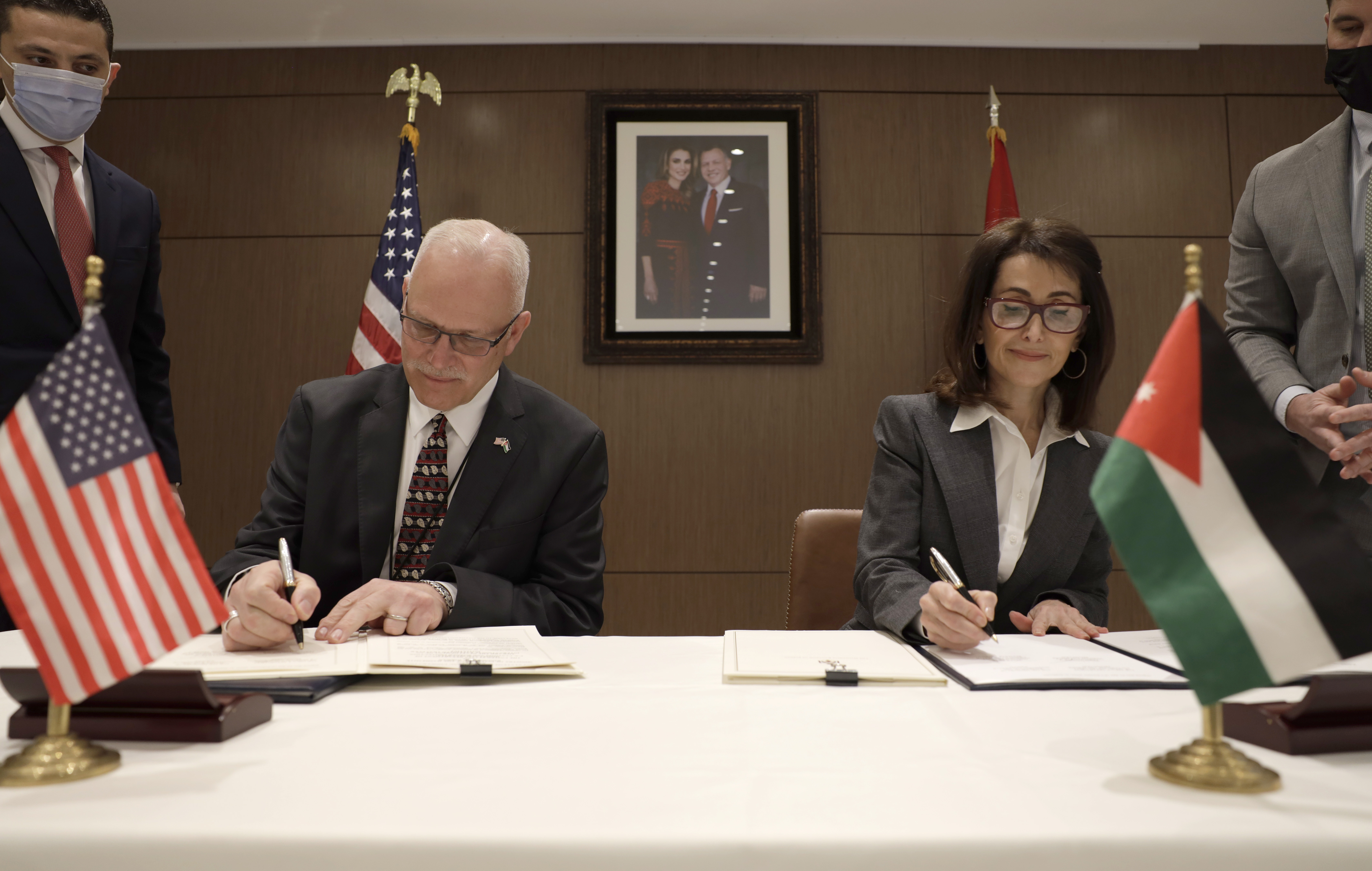 CBP Commissioner Chris Magnus signs a Global Entry joint statement with Jordanian Ambassador Dina Kawar.