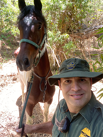 Border Patrol Agent with found horse, Ollie