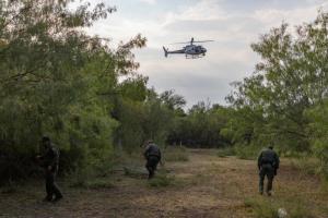 An Air and Marine Operations AS350 A-Star helicopter from the McAllen Air Branch works with Border Patrol agents tracking a group near Penitas, Texas. Photo by Rod Kise