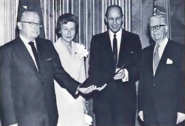 Photo of Commissioner Lester D. Johnson receiving the Treasury's Exceptional Service Award from Secretary Henry H. Fowler