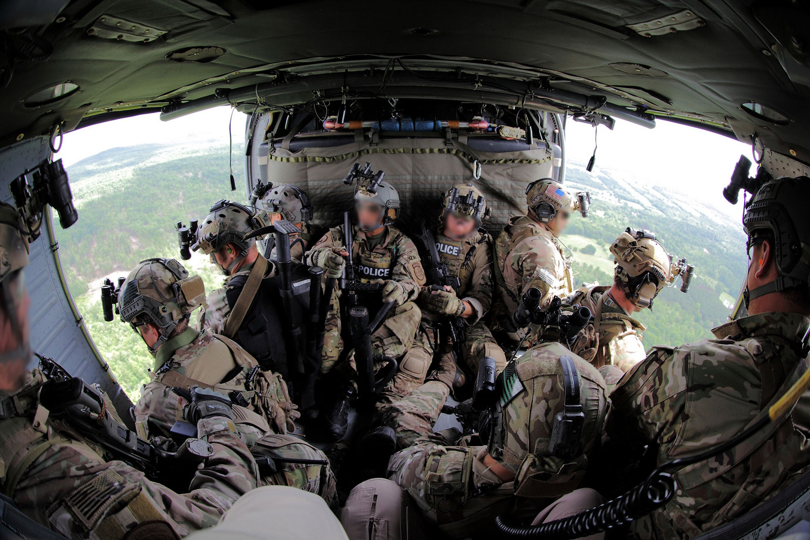 Photo of a search team in a Black Hawk helicopter
