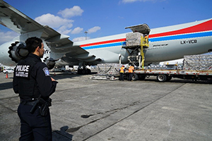 Officer waiting to inspect supplies at airport