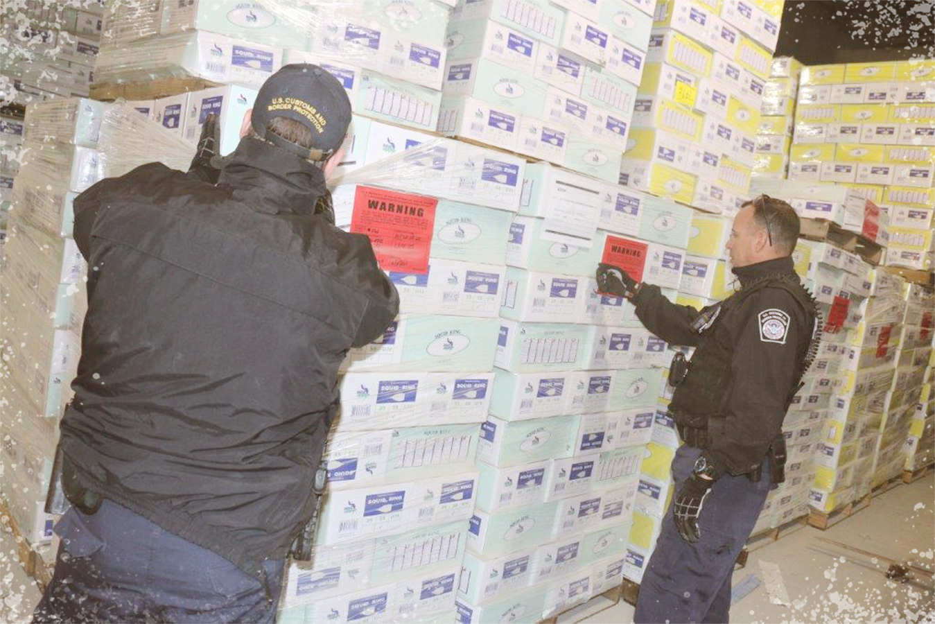 CBP Office of Field Operations Seized Property Specialists Gary Dziatko (left) and Michael Morejon inspect boxes of frozen squid