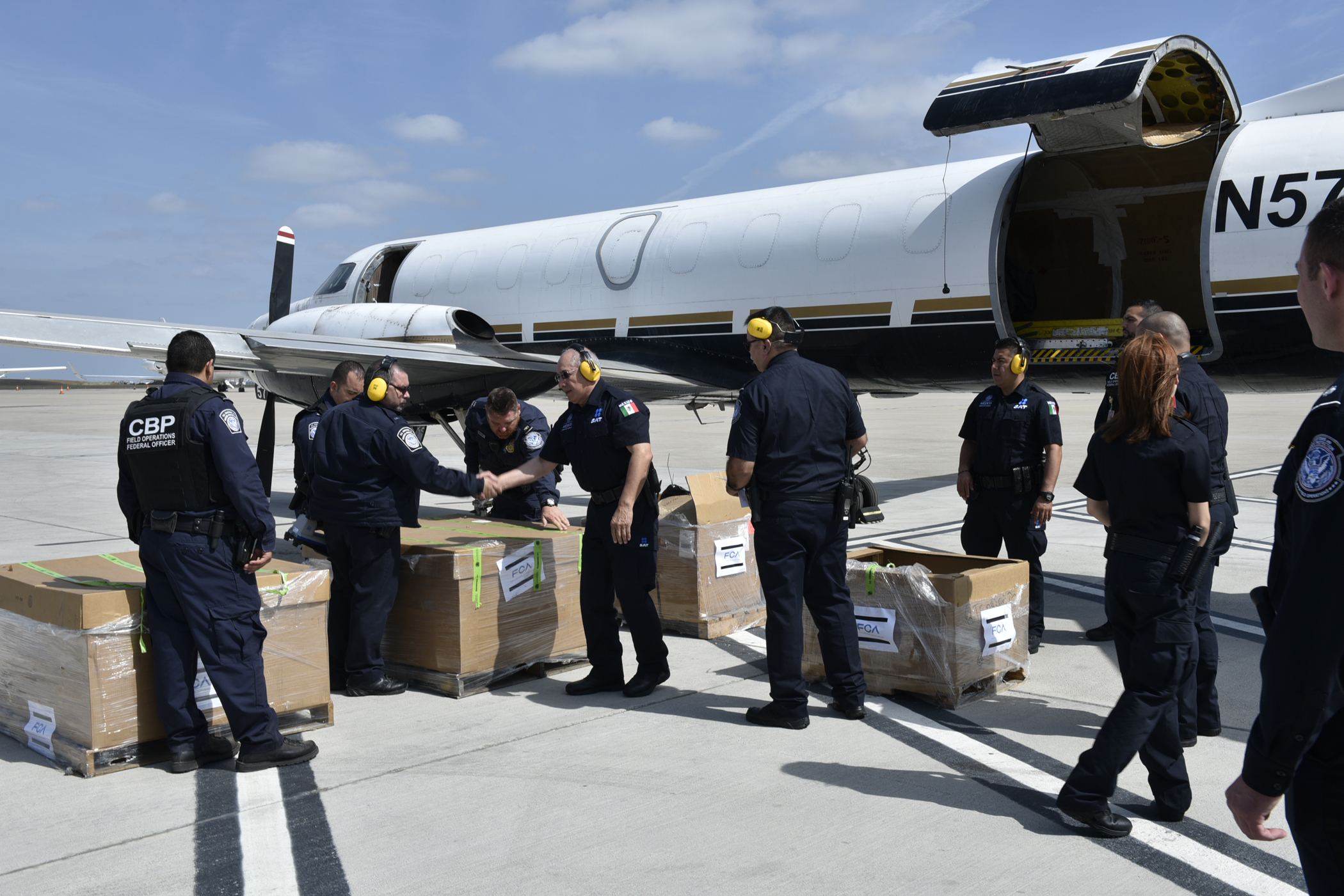 CBP officers onspect a shipment before the flight continues