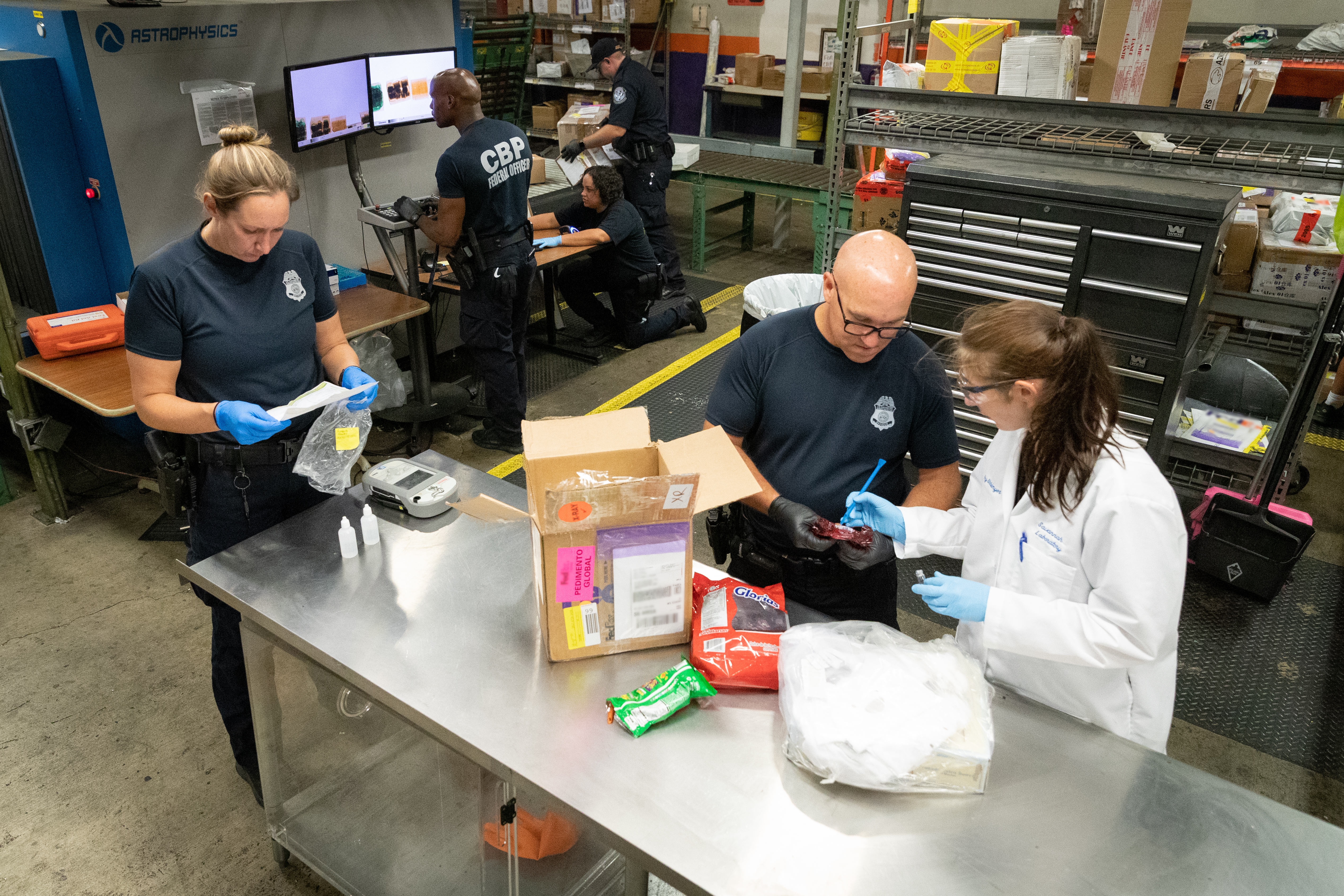 CBP employees work in a triage area