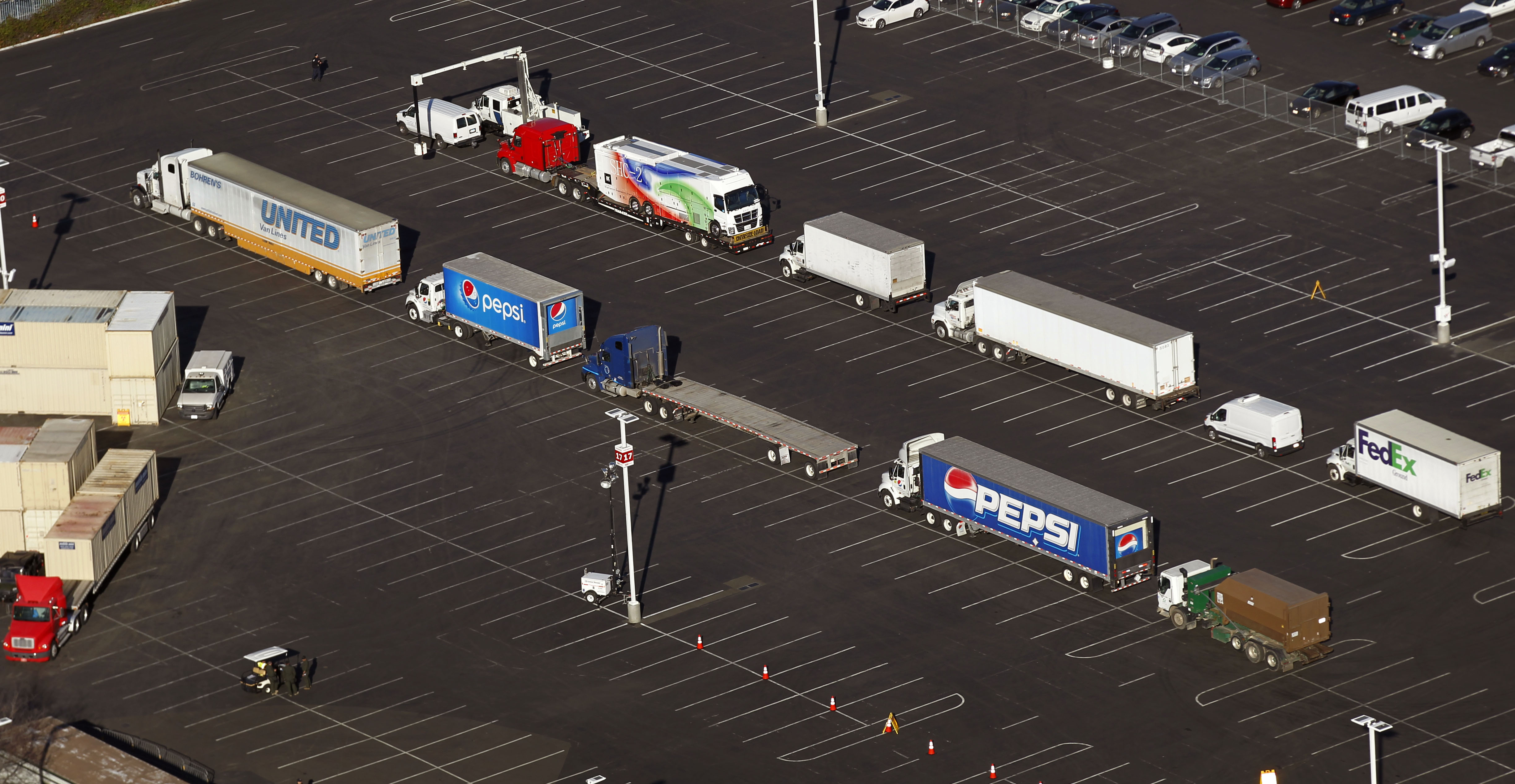 Photo of trucks lined up next to Levi's Stadium for X-ray screening before deliveries to the stadium are authorized