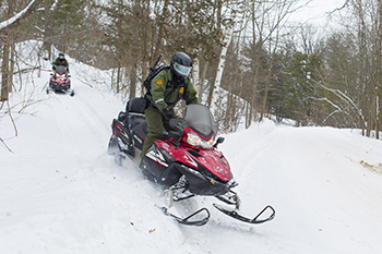 Border Patrol agents on snowmobiles along the Northern Border