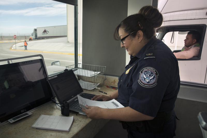 CBP Officer Oralia Macias checks the paperwork of a Mexican trucker headed for the U.S. at the San Jeronimo, Mexico, unified cargo processing, or UCP, facility. Photo by Donna Burton
