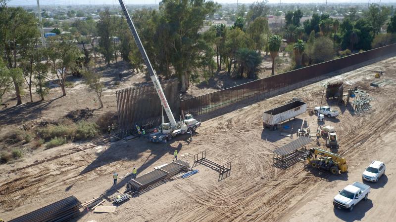A section of new, steel bollard-style replacement wall goes up near Calexico, California, about two hours east of San Diego. Photo by Mani Albrecht