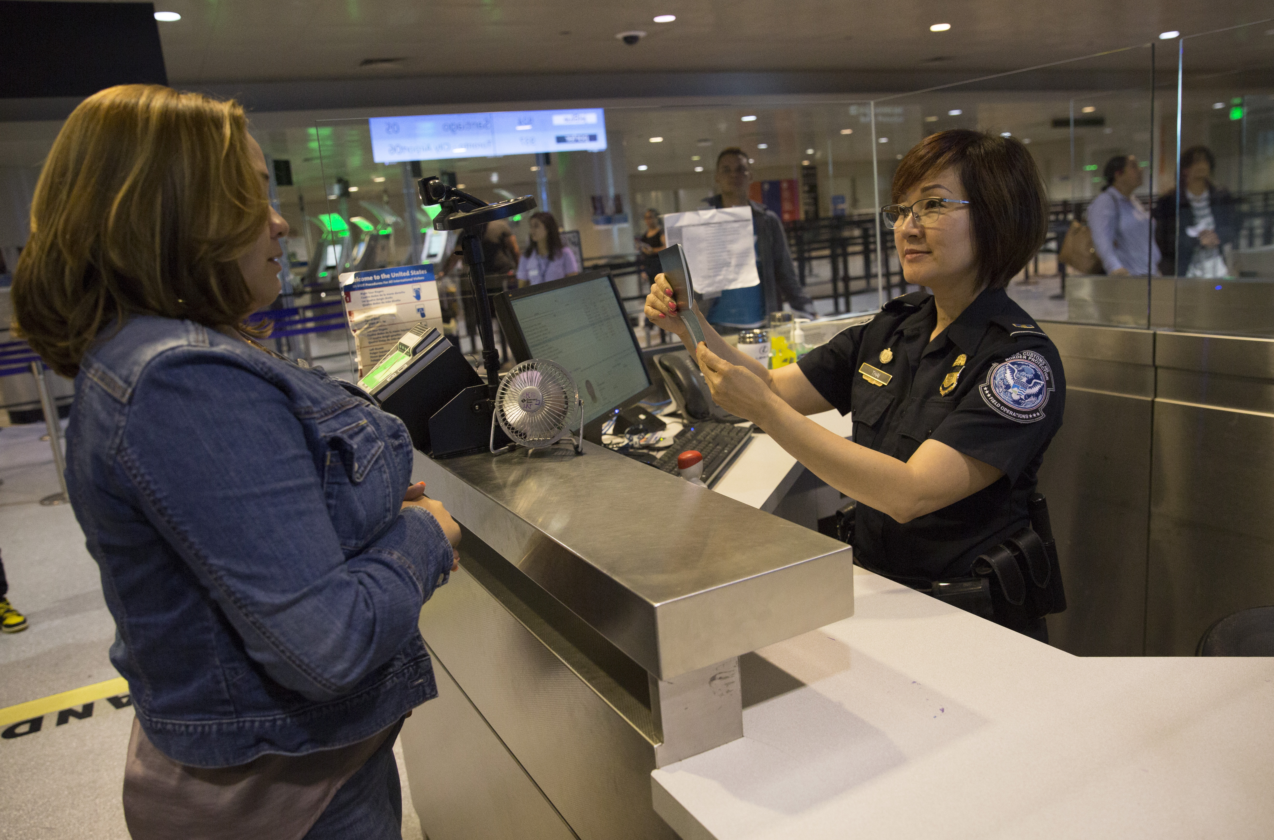 A CBP officer processes an international passenger at Boston Logan International Airport. 