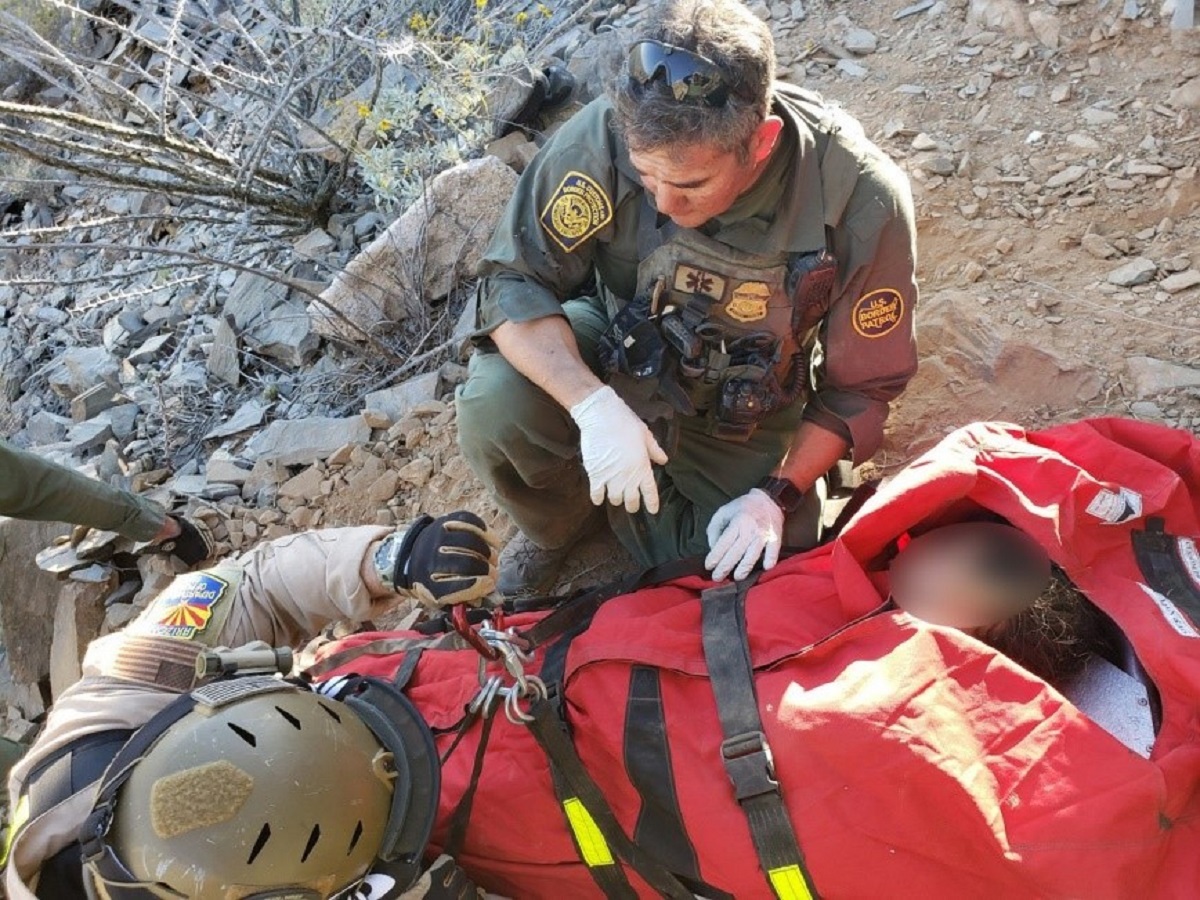 Arizona Department of Public Safety officer, above left, assists a Border Patrol agent with a medical extraction in Arizona 