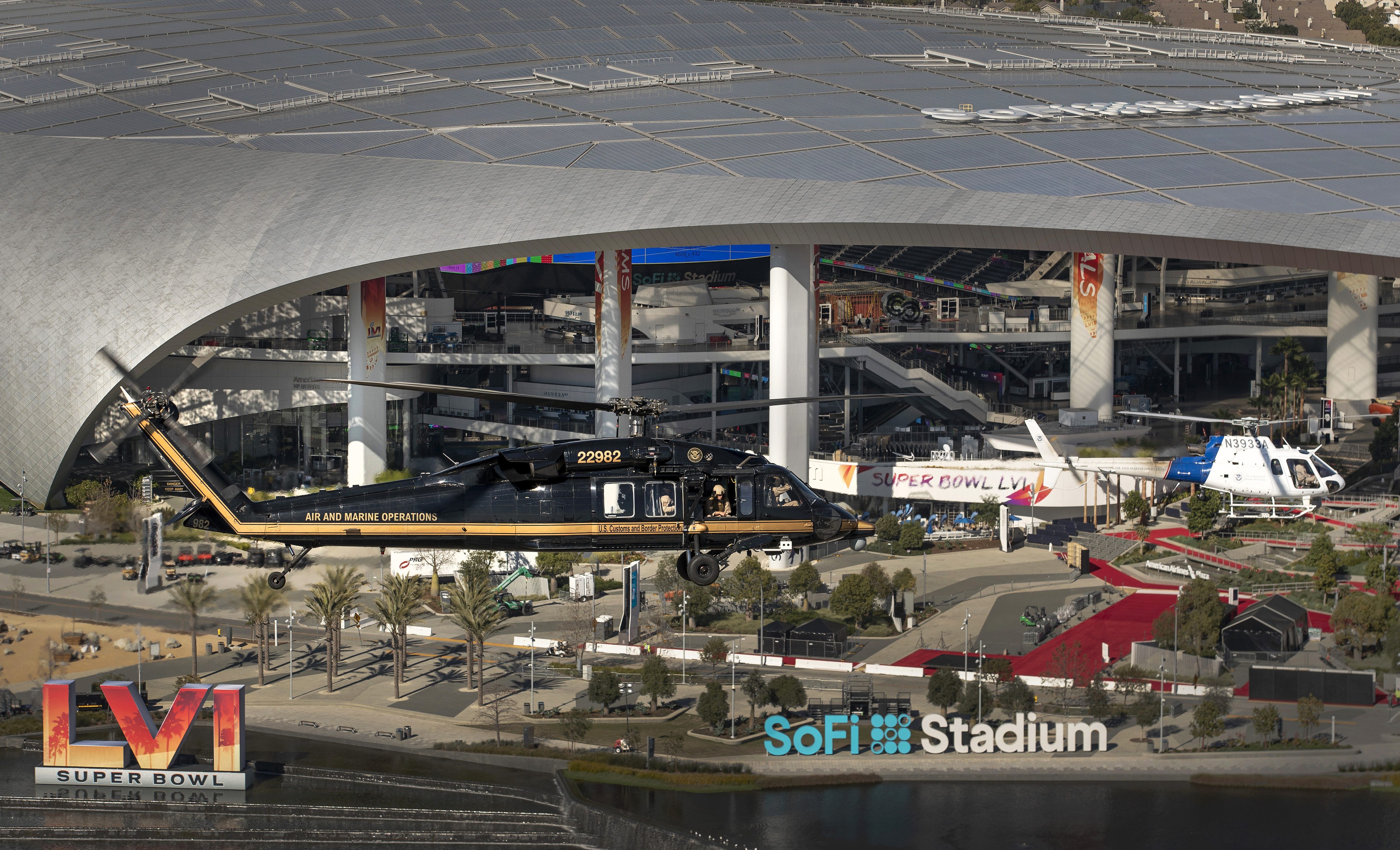 Two Air and Marine Operations helicopters fly over the Super Bowl stadium in 2022.
