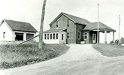 1940's photograph of the U.S. Customs and U.S. Immigration border inspection station at Morses Line, Vt. The border station was built in 1935 on the west side of Morses Line Road (State Route 235), and contained a small office on the first floor plus residential quarters for the Customs and Immigration officers stationed at the port.