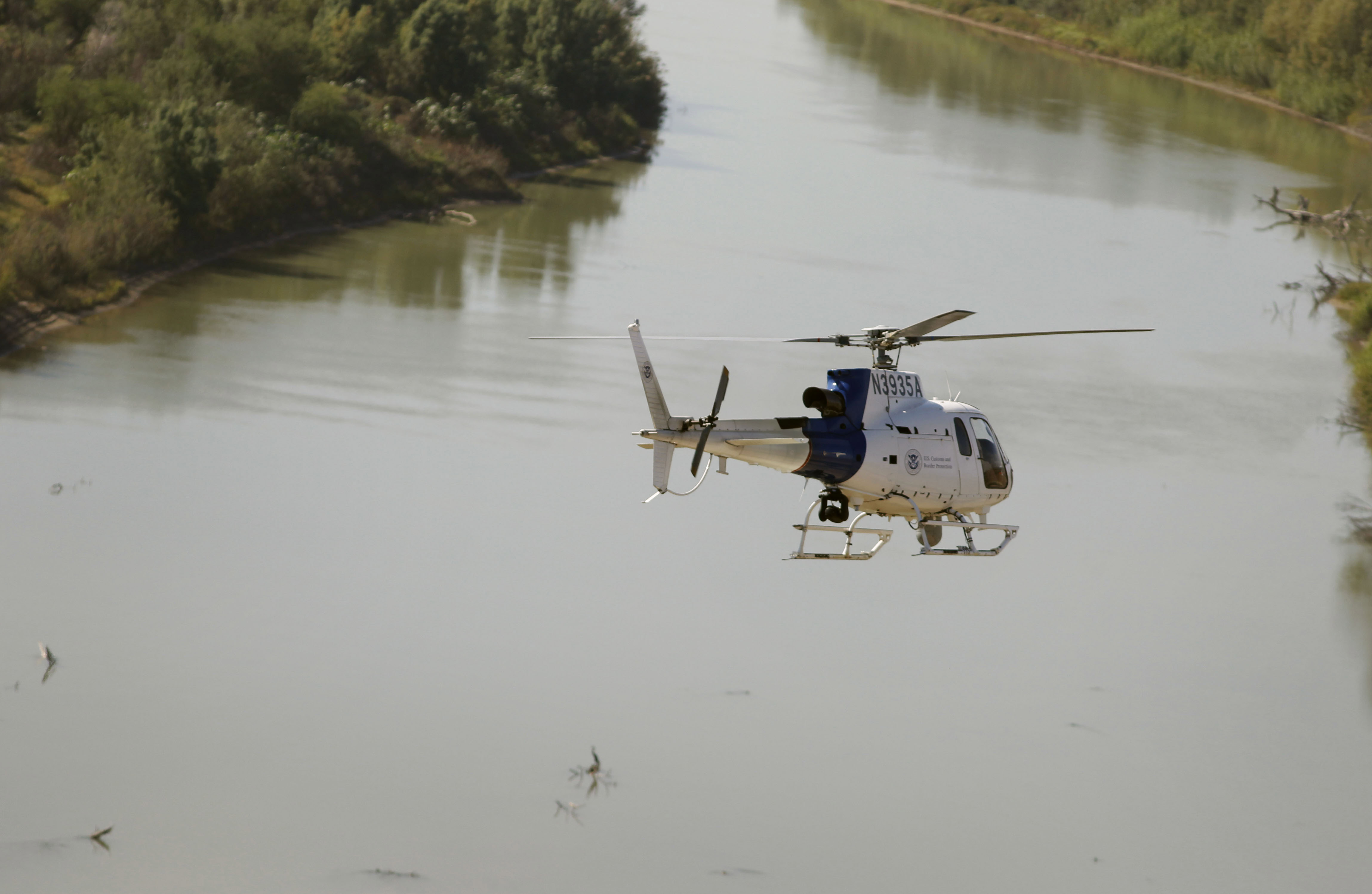 An Air and Marine Operations  AS350 crew flies over the Rio Grande River during a border security patrol near McAllen, Texas. 