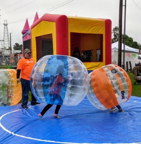 A cloudy, chilly day did not stop children from enjoying a friendly battle of bubble ball and bounce houses right outside the Humble Civic Center. 